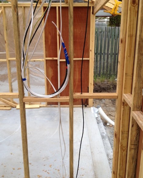 Timber wall frame during rough-in with electrical cabling run through the studs