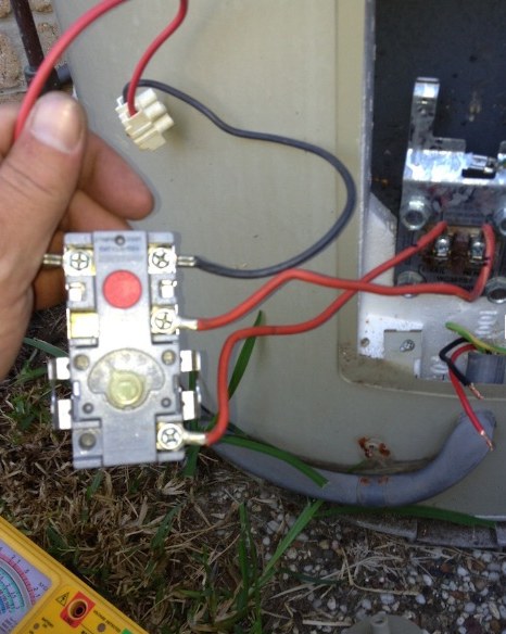 Electrician testing a power point with a multimeter during a repair